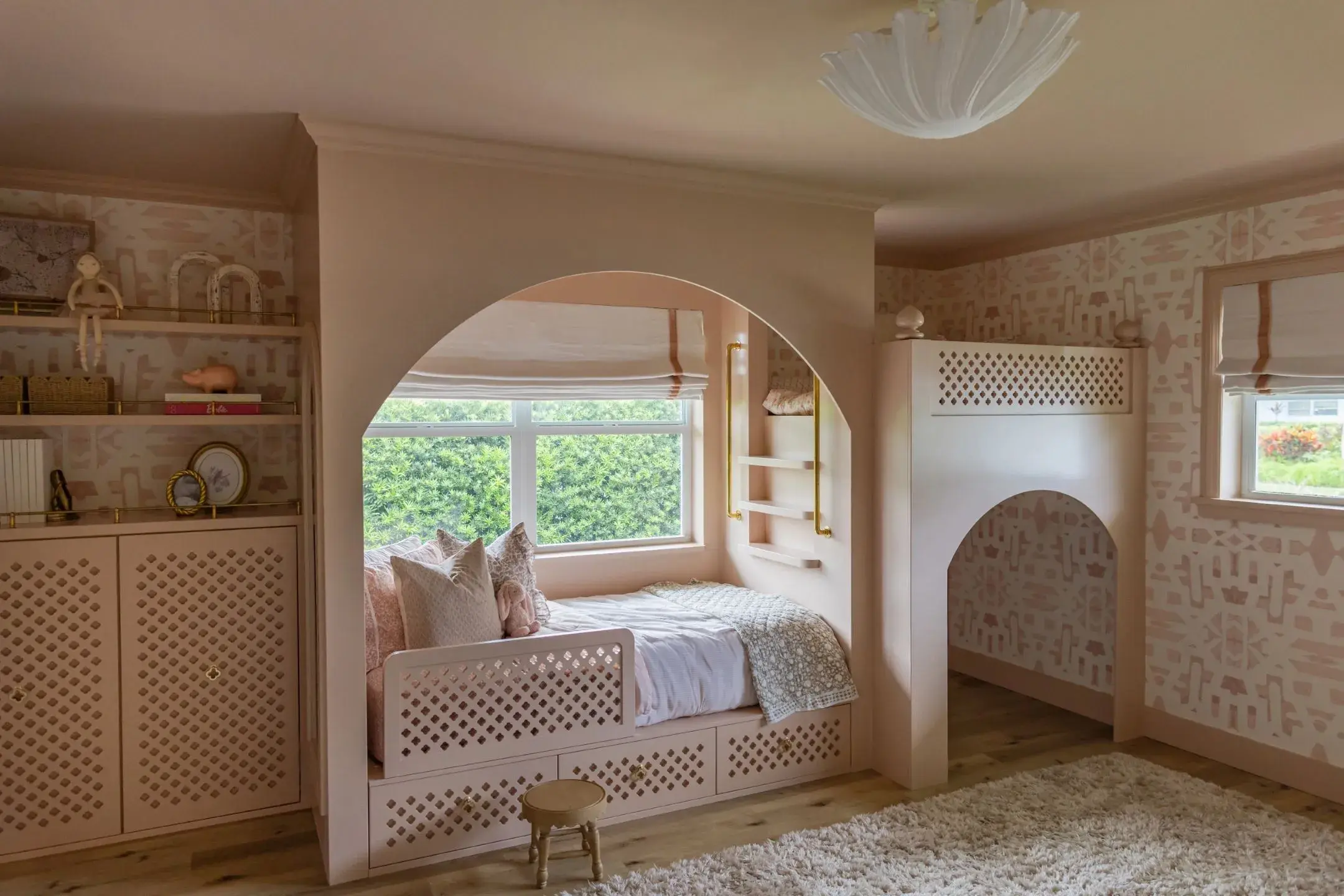 Dusty pink bedroom with storage, bed, and playcastle