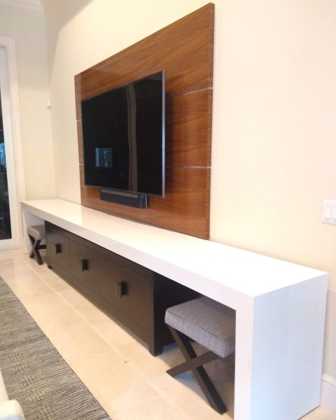 Teak wall paneling and white console table