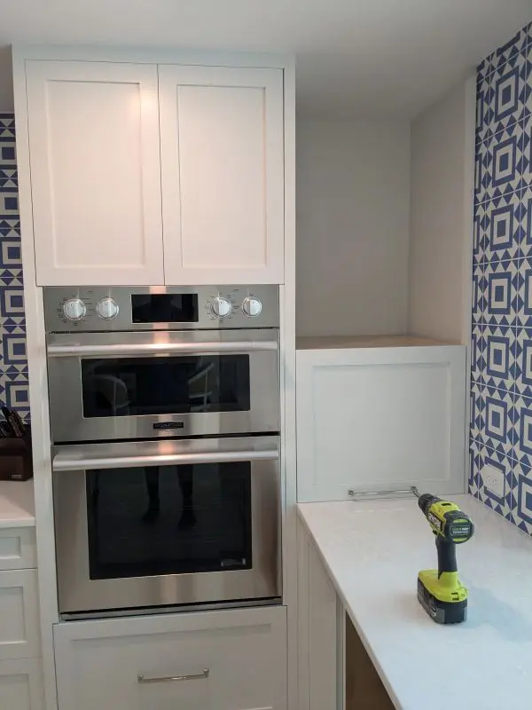 Partially installed white kitchen